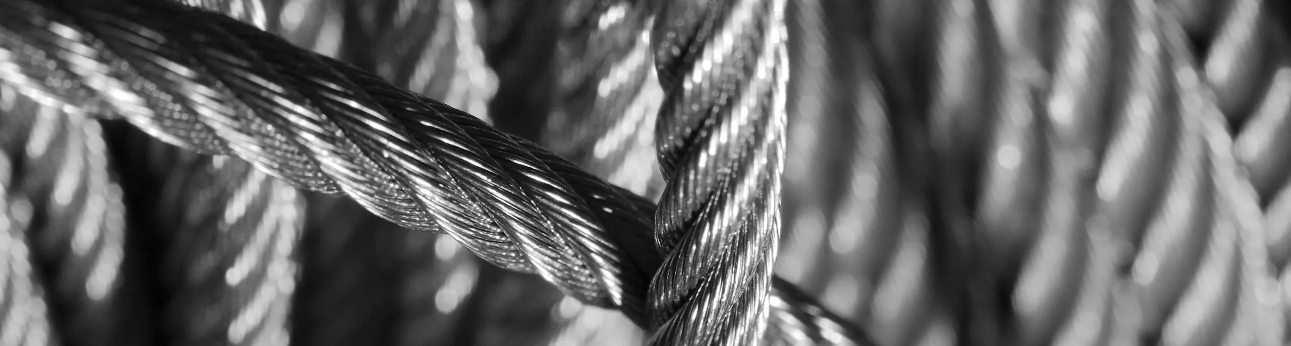 Close-up view of steel wire rope strands showing twisted helical structure in high detail