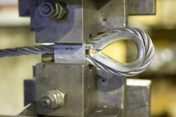 wire rope sling termination using hydraulic press and thimble eye fitting
