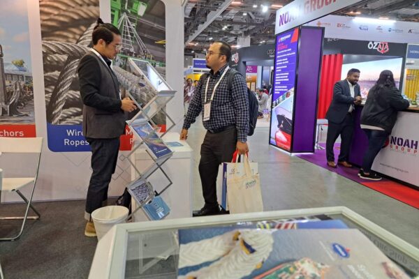 Visitor engaging with Katradis brochures at Sea Asia 2025